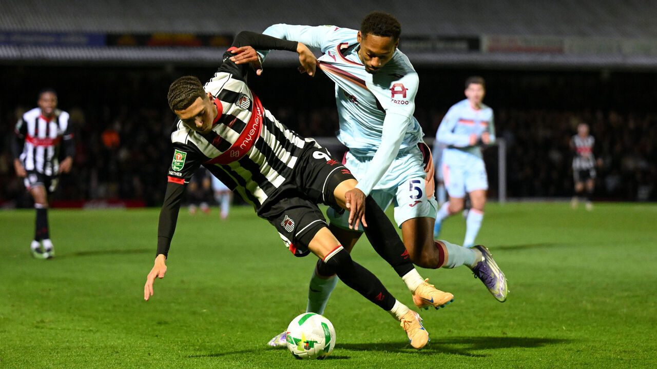 GRIMSBY, ENGLAND - OCTOBER 28: Jaze Kabia of Grimsby Town is challenged by Ethan Pinnock of Brentford during the Carabao Cup Fourth Round match between Grimsby Town and Brentford at Blundell Park on October 28, 2025 in Grimsby, England.