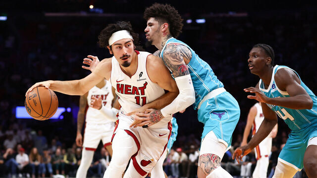 MIAMI, FLORIDA - OCTOBER 28: Jaime Jaquez Jr. #11 of the Miami Heat dribbles the ball to the basket against LaMelo Ball #1 of the Charlotte Hornets during the first quarter of the game at Kaseya Center on October 28, 2025 in Miami, Florida.
