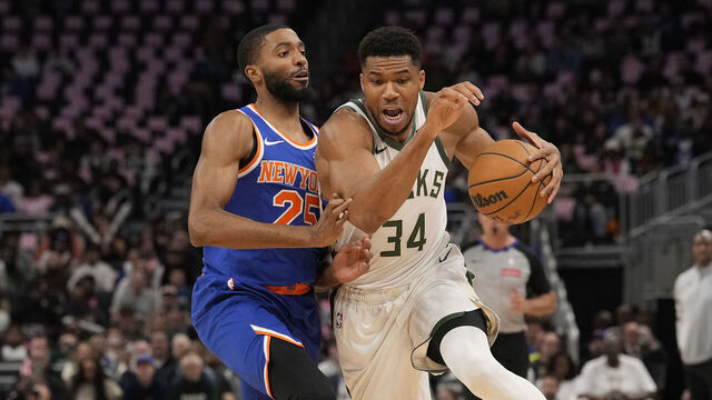 MILWAUKEE, WISCONSIN - OCTOBER 28: Giannis Antetokounmpo #34 of the Milwaukee Bucks dribbles the ball against Mikal Bridges #25 of the New York Knicks during the first quarter at Fiserv Forum on October 28, 2025 in Milwaukee, Wisconsin.