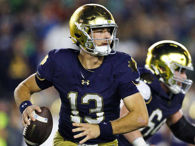 SOUTH BEND, INDIANA - OCTOBER 18: CJ Carr #13 of the Notre Dame Fighting Irish rolls out to pass during the game against USC Trojans at Notre Dame Stadium on October 18, 2025 in South Bend, Indiana.