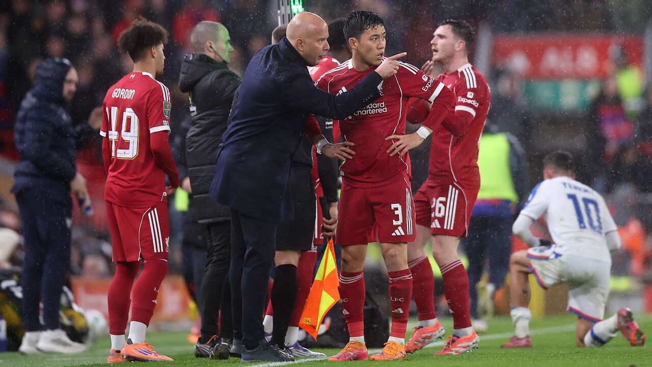 LIVERPOOL, ENGLAND - OCTOBER 29: Liverpool Manager Arne Slot gives instructions to Wataru Endo of Liverpool during the Carabao Cup Fourth Round match between Liverpool and Crystal Palace at Anfield on October 29, 2025 in Liverpool, England.