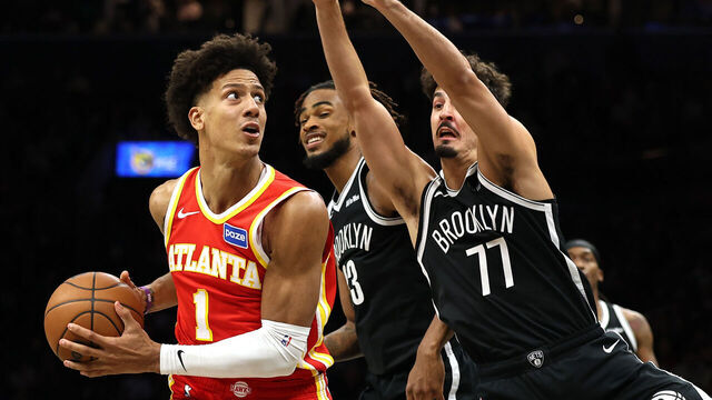 NEW YORK, NEW YORK - OCTOBER 29: Jalen Johnson #1 of the Atlanta Hawks dribbles against Nic Claxton #33 and Ben Saraf #77 of the Brooklyn Nets during the second half at Barclays Center on October 29, 2025 in New York City. The Hawks won 117-112.