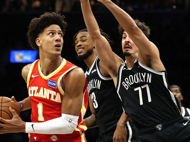 NEW YORK, NEW YORK - OCTOBER 29: Jalen Johnson #1 of the Atlanta Hawks dribbles against Nic Claxton #33 and Ben Saraf #77 of the Brooklyn Nets during the second half at Barclays Center on October 29, 2025 in New York City. The Hawks won 117-112.