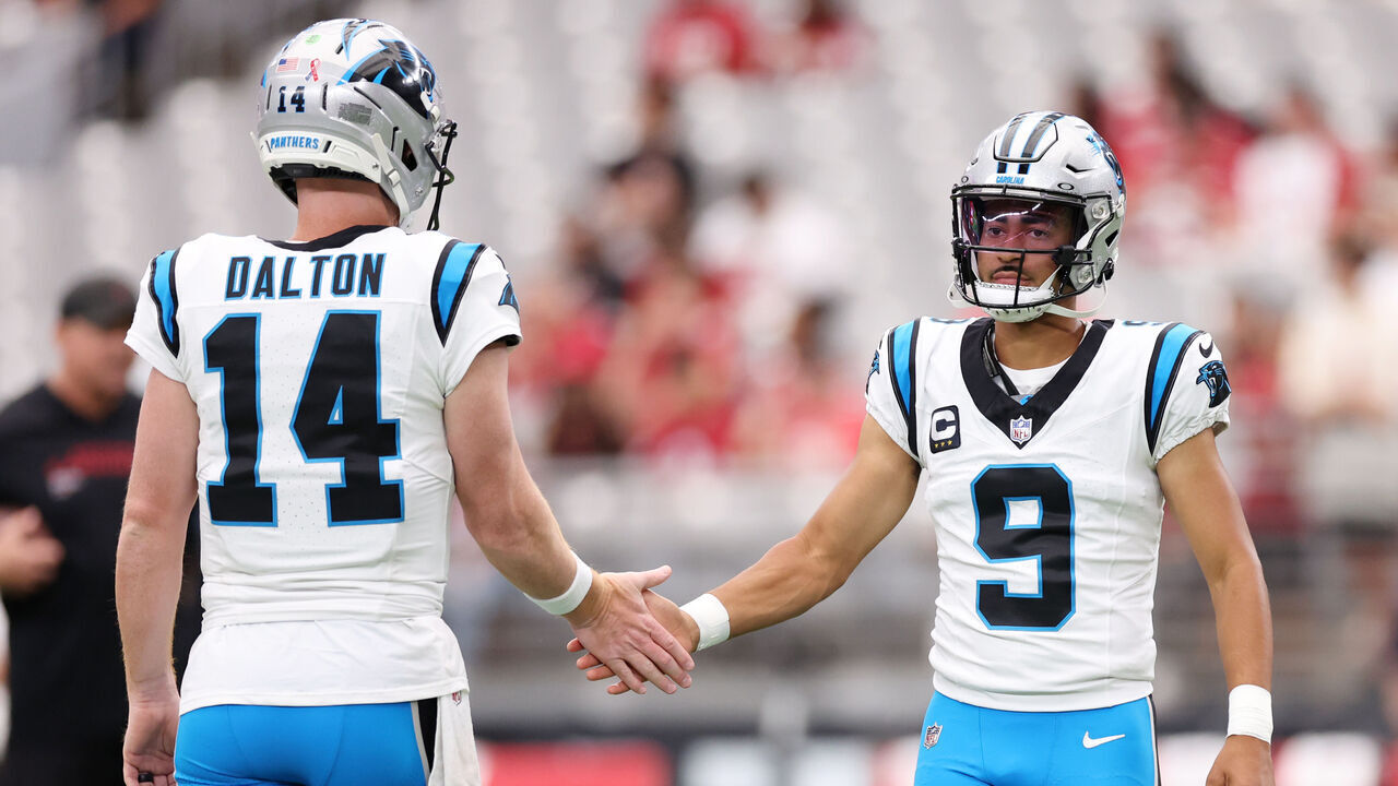 GLENDALE, ARIZONA - SEPTEMBER 14: Bryce Young #9 and Andy Dalton #14 of the Carolina Panthers warm up prior to a game against the Arizona Cardinals at State Farm Stadium on September 14, 2025 in Glendale, Arizona.