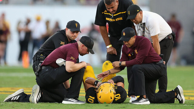 TEMPE, ARIZONA - OCTOBER 25: Sam Leavitt #10 of the Arizona State Sun Devils is looked at by team trainers and head coach Kenny Dillingham during the first quarter of the NCAAF game against the Houston Cougars at Mountain America Stadium on October 25, 2025 in Tempe, Arizona.