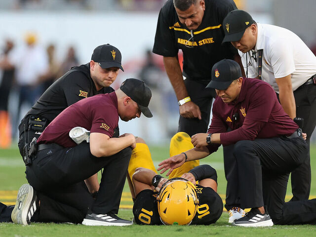 TEMPE, ARIZONA - OCTOBER 25: Sam Leavitt #10 of the Arizona State Sun Devils is looked at by team trainers and head coach Kenny Dillingham during the first quarter of the NCAAF game against the Houston Cougars at Mountain America Stadium on October 25, 2025 in Tempe, Arizona.