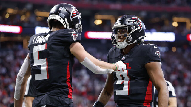 ATLANTA, GEORGIA - JANUARY 5: Michael Penix Jr. #9 and Drake London #5 of the Atlanta Falcons react following a touchdown during the second quarter against the Carolina Panthers at Mercedes-Benz Stadium on January 5, 2025 in Atlanta, Georgia.