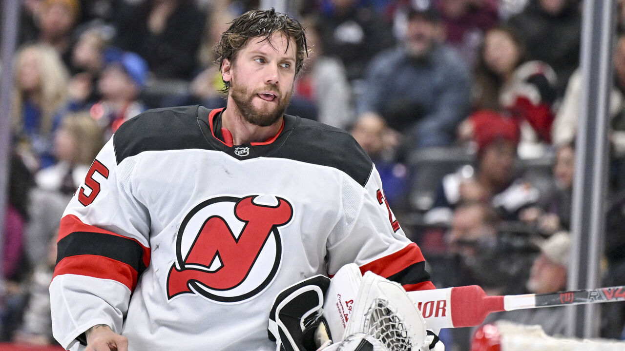 DENVER , CO - OCTOBER 28: Jacob Markstrom (25) of the New Jersey Devils prepares to put his helmet back on after it was knocked off when Nathan MacKinnon (29) of the Colorado Avalanche shot on net during the first period at Ball Arena on Tuesday, October 28, 2025.