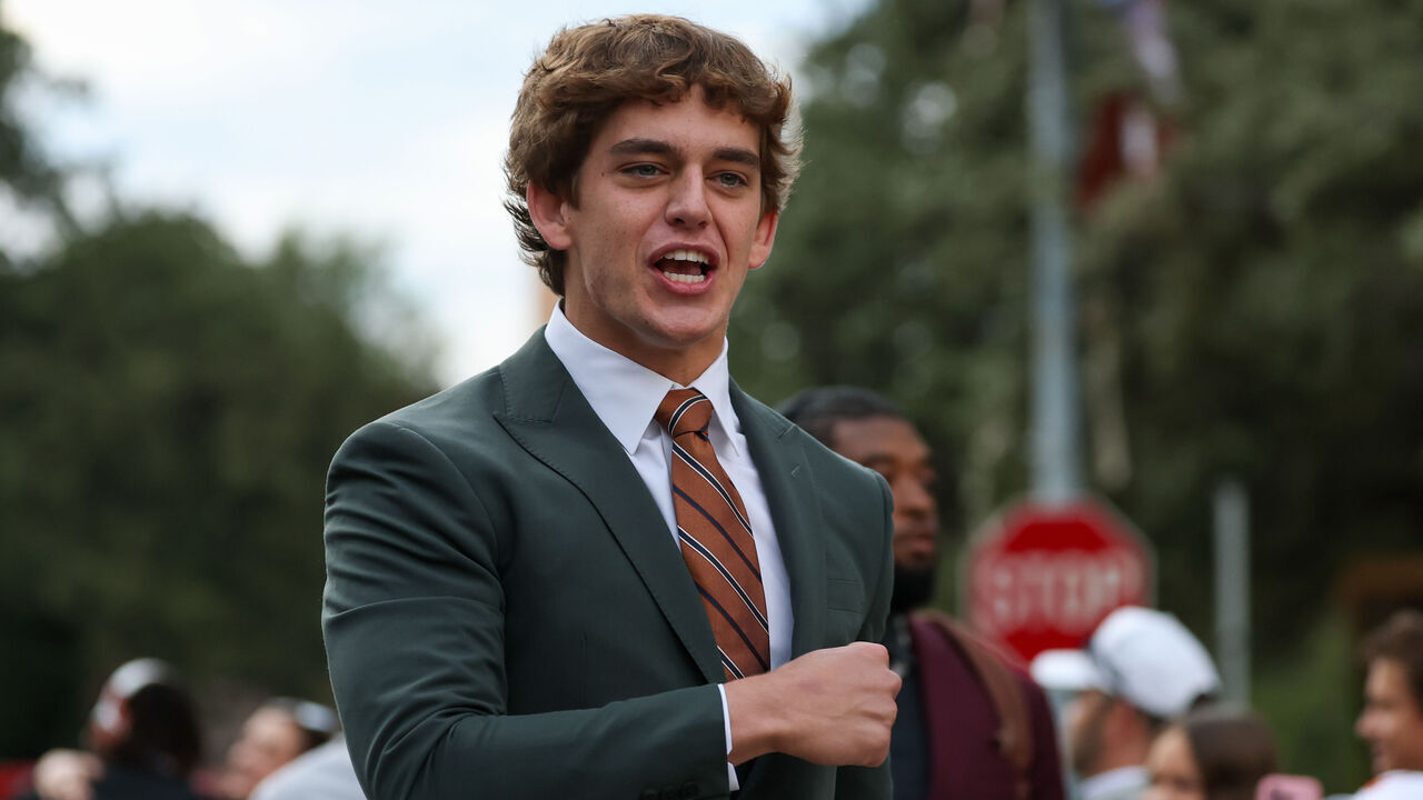 AUSTIN, TX - NOVEMBER 01: Quarterback Arch Manning #16 of the Texas Longhorns pumps his fist and screams "let's go" to fans as he walks into the stadium before the SEC college football between Texas Longhorns and Vanderbilt Commodores on November 1, 2025, at Darrell K Royal-Texas Memorial Stadium in Austin, TX.