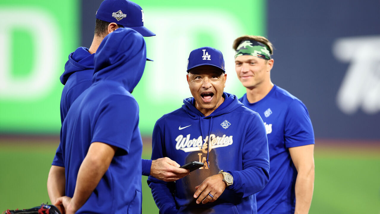TORONTO, ON - OCTOBER 30: Manager Dave Roberts of the Los Angeles Dodgers reacts after falling on the ground between second and third base while having a running race with Hyeseong Kim #6 during a workout day ahead of game six of the 2025 World Series at Rogers Centre on October 30, 2025 in Toronto, Ontario, Canada.