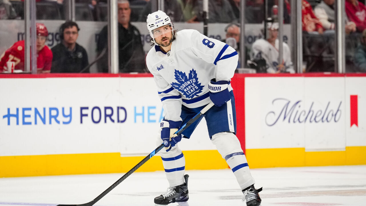 DETROIT, MICHIGAN - OCTOBER 11: Chris Tanev #8 of the Toronto Maple Leafs skates with the puck against the Detroit Red Wings at Little Caesars Arena on October 11, 2025 in Detroit, Michigan.