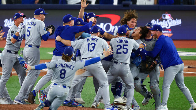 TORONTO, ONTARIO - NOVEMBER 02: Yoshinobu Yamamoto #18 of the Los Angeles Dodgers (R) celebrates with teammates after defeating the Toronto Blue Jays 5-4 in game seven of the 2025 World Series at Rogers Center on November 02, 2025 in Toronto, Ontario.