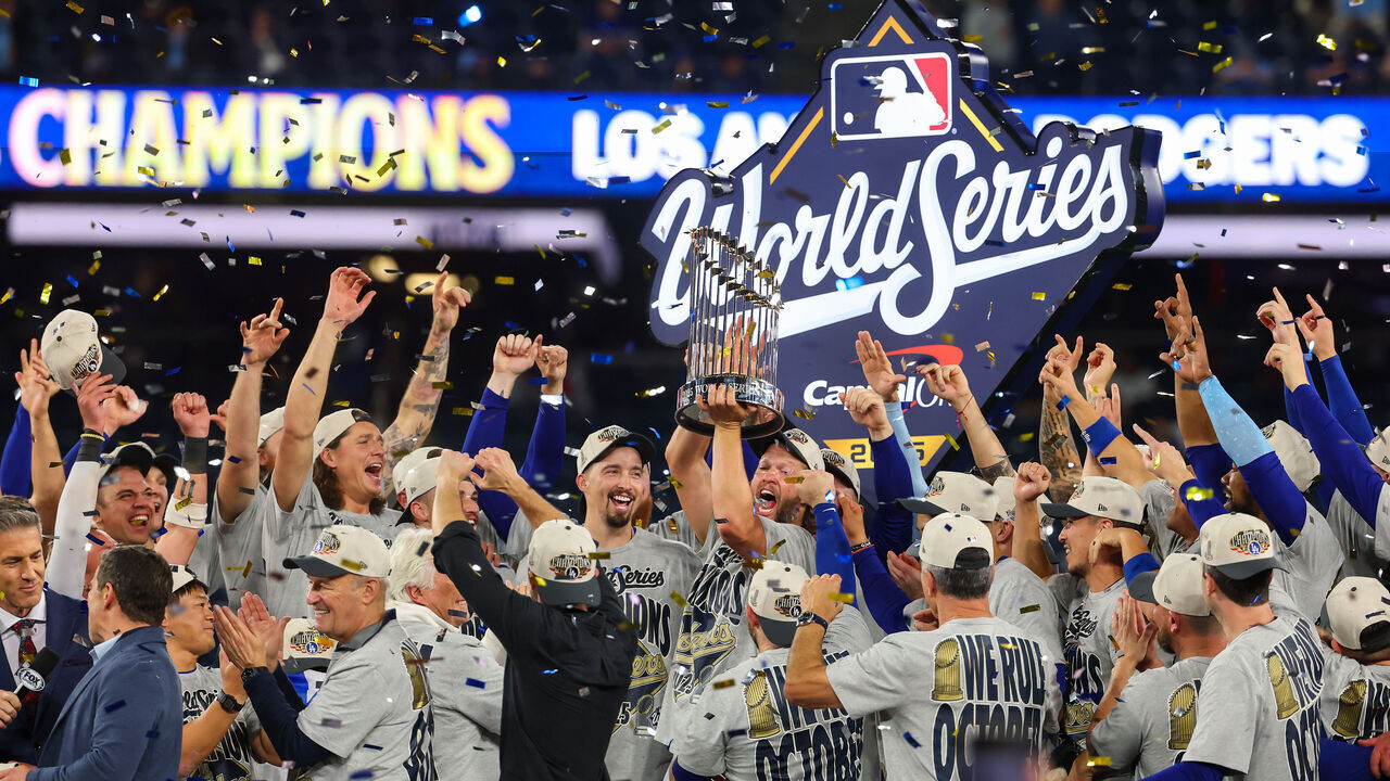 TORONTO, ONTARIO - NOVEMBER 02: Clayton Kershaw #22 of the Los Angeles Dodgers raises the Commisioner's Trophy after defeating the Toronto Blue Jays 5-4 in game seven of the 2025 World Series at Rogers Center on November 02, 2025 in Toronto, Ontario.