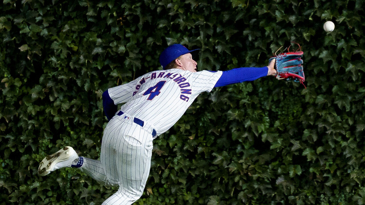 CHICAGO, ILLINOIS - SEPTEMBER 25: Pete Crow-Armstrong #4 of the Chicago Cubs steals a hit away from Juan Soto #22 of the New York Mets after making a catch in a game at Wrigley Field on September 25, 2025 in Chicago, Illinois.
