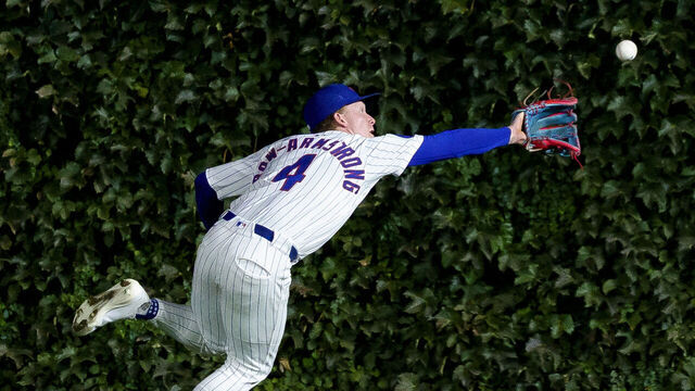 CHICAGO, ILLINOIS - SEPTEMBER 25: Pete Crow-Armstrong #4 of the Chicago Cubs steals a hit away from Juan Soto #22 of the New York Mets after making a catch in a game at Wrigley Field on September 25, 2025 in Chicago, Illinois.