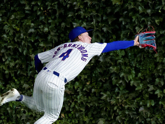 CHICAGO, ILLINOIS - SEPTEMBER 25: Pete Crow-Armstrong #4 of the Chicago Cubs steals a hit away from Juan Soto #22 of the New York Mets after making a catch in a game at Wrigley Field on September 25, 2025 in Chicago, Illinois.