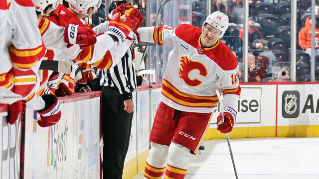 PHILADELPHIA, PENNSYLVANIA - NOVEMBER 02: Jonathan Huberdeau #10 of the Calgary Flames celebrates his third period goal against the Philadelphia Flyers with his teammates on the bench at the Xfinity Mobile Arena on November 2, 2025 in Philadelphia, Pennsylvania. The goal was Huberdeau's second of the game.