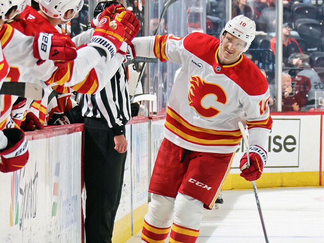 PHILADELPHIA, PENNSYLVANIA - NOVEMBER 02: Jonathan Huberdeau #10 of the Calgary Flames celebrates his third period goal against the Philadelphia Flyers with his teammates on the bench at the Xfinity Mobile Arena on November 2, 2025 in Philadelphia, Pennsylvania. The goal was Huberdeau's second of the game.