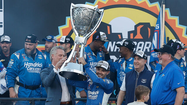 AVONDALE, AZ - NOVEMBER 02: Kyle Larson (#5 Hendrick Motorsports HendrickCars.com Chevrolet) lifts the trophy after winning the NASCAR Cup Series Championship on November 2, 2025 at Phoenix Raceway in Avondale, Arizona.