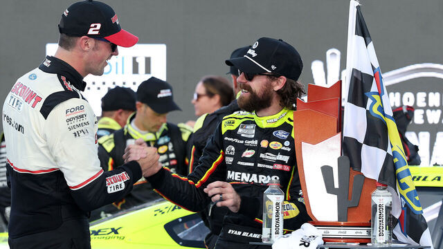 AVONDALE, ARIZONA - NOVEMBER 02: Austin Cindric, driver of the #2 Discount Tire Ford, (L) congratulates Ryan Blaney, driver of the #12 Menards/Dutch Boy Ford, in victory lane after winning the NASCAR Cup Series Championship race at Phoenix Raceway on November 02, 2025 in Avondale, Arizona.