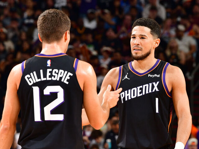 PHOENIX, AZ - NOVEMBER 2: Collin Gillespie #12 and Devin Booker #1 of the Phoenix Suns high five during the game against the San Antonio Spurs on November 2, 2025 at PHX Arena in Phoenix, Arizona. Mandatory Copyright Notice: Copyright 2025 NBAE