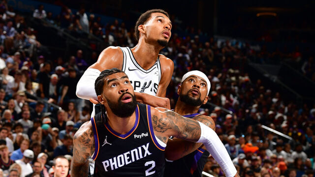 PHOENIX, AZ - NOVEMBER 2: Nick Richards #2, Jordan Goodwin #23 of the Phoenix Suns and Victor Wembanyama #1 of the San Antonio Spurs box out during the game on November 2, 2025 at PHX Arena in Phoenix, Arizona. Mandatory Copyright Notice: Copyright 2025 NBAE