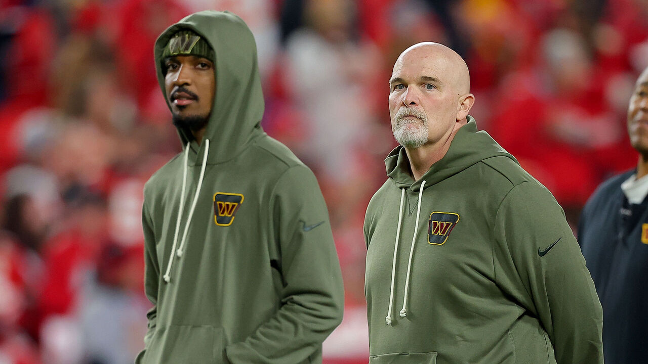 KANSAS CITY, MISSOURI - OCTOBER 27: (L-R) Jayden Daniels #5 and head coach Dan Quinn of the Washington Commanders talk prior to the game against the Kansas City Chiefs at Arrowhead Stadium on October 27, 2025 in Kansas City, Missouri.