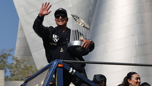 LOS ANGELES, CALIFORNIA - NOVEMBER 03: Manager Dave Roberts of the Los Angeles Dodgers celebrates on a bus with the Commissioner's Trophy during the Dodgers 2025 World Series Championship parade on November 03, 2025 in Los Angeles, California.
