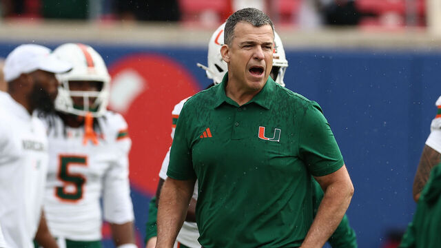 DALLAS, TX - November 01: Miami Hurricanes head coach Mario Cristobal looks on during warm ups during the college football game between the SMU Mustangs and the Miami Hurricanes on November 1, 2025, at Gerald J. Ford Stadium in Dallas, TX.