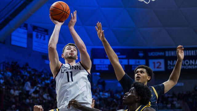 STORRS, CONNECTICUT - NOVEMBER 03: Alex Karaban #11 of the Connecticut Huskies shoots against Najimi George #23 and Andre Pasha #15 of the New Haven Chargers during the second half of an NCAA men's basketball game at Harry A. Gampel Pavilion on November 03, 2025 in Storrs, Connecticut.