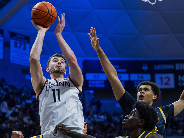 STORRS, CONNECTICUT - NOVEMBER 03: Alex Karaban #11 of the Connecticut Huskies shoots against Najimi George #23 and Andre Pasha #15 of the New Haven Chargers during the second half of an NCAA men's basketball game at Harry A. Gampel Pavilion on November 03, 2025 in Storrs, Connecticut.
