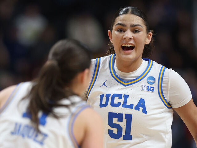 SPOKANE, WASHINGTON - MARCH 30: Lauren Betts #51 of the UCLA Bruins reacts with Gabriela Jaquez #11 during the second half against the LSU Lady Tigers in the Elite Eight round of the NCAA Women's Basketball Tournament at Spokane Arena on March 30, 2025 in Spokane, Washington.