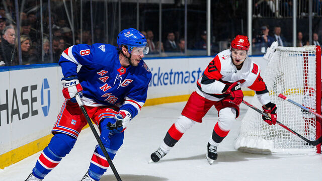 NEW YORK, NEW YORK - NOVEMBER 04: J.T. Miller #8 of the New York Rangers skates with the puck against Sebastian Aho #20 of the Carolina Hurricanes at Madison Square Garden on November 4, 2025 in New York City.