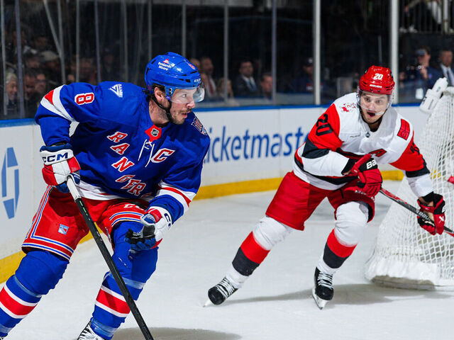 NEW YORK, NEW YORK - NOVEMBER 04: J.T. Miller #8 of the New York Rangers skates with the puck against Sebastian Aho #20 of the Carolina Hurricanes at Madison Square Garden on November 4, 2025 in New York City.