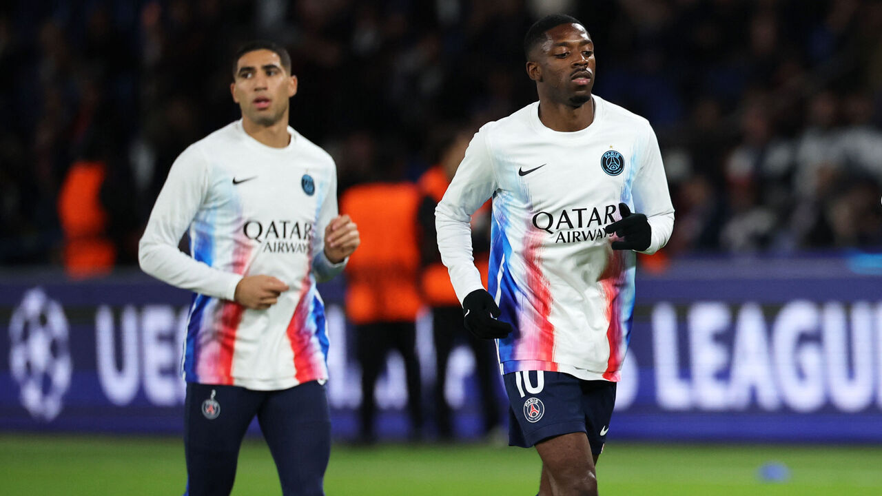 (From L) Paris Saint-Germain's Moroccan defender #02 Achraf Hakimi, Paris Saint-Germain's French forward #10 Ousmane Dembele and Paris Saint-Germain's Georgian forward #07 Khvicha Kvaratskhelia warm up ahead of the UEFA Champions League, league phase day 4, football match between Paris Saint-Germain (PSG) and FC Bayern Munich at the Parc des Princes in Paris, on November 4, 2025.