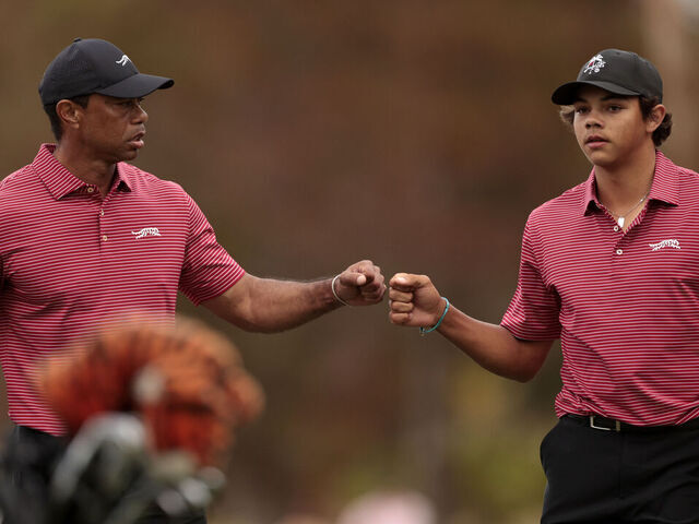 ORLANDO, FLORIDA - DECEMBER 22: Tiger Woods of the United States and his son Charlie Woods react on the 16th green during the second round of the PNC Championship at Ritz-Carlton Golf Club on December 22, 2024 in Orlando, Florida.