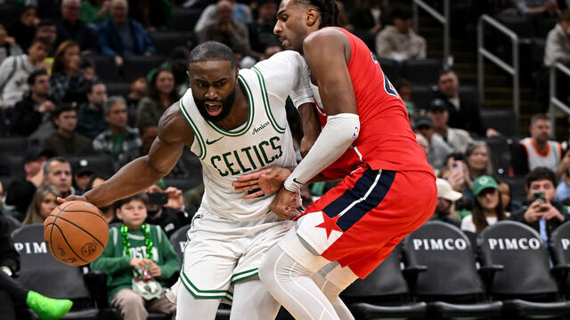 BOSTON, MASSACHUSETTS - NOVEMBER 05: Jaylen Brown #7 of the Boston Celtics goes to the basket against Alex Sarr #20 of the Washington Wizards during the second half at the TD Garden on November 05, 2025 in Boston, Massachusetts.