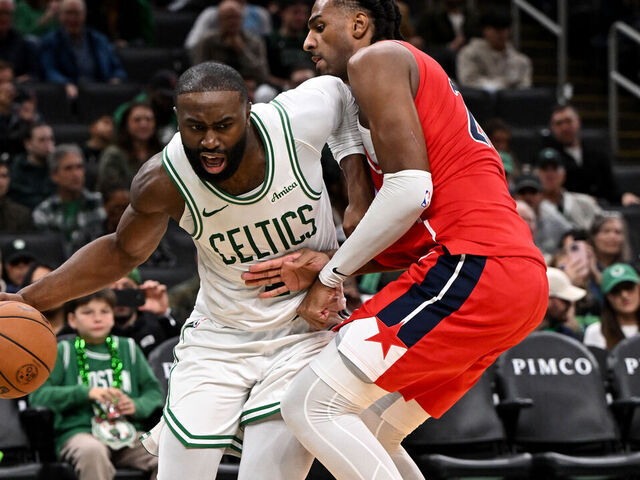 BOSTON, MASSACHUSETTS - NOVEMBER 05: Jaylen Brown #7 of the Boston Celtics goes to the basket against Alex Sarr #20 of the Washington Wizards during the second half at the TD Garden on November 05, 2025 in Boston, Massachusetts.