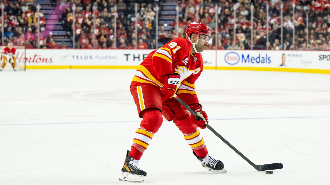 CALGARY, CANADA - NOVEMBER 5: Nazem Kadri #91 of the Calgary Flames, playing in his 1000th NHL game, skates with the puck against the Columbus Blue Jackets during the first period at the Scotiabank Saddledome on November 5, 2025 in Calgary, Canada.