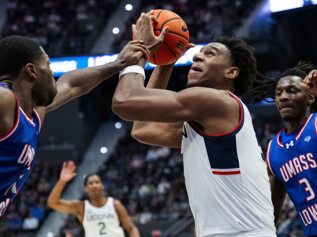 HARTFORD, CONNECTICUT - NOVEMBER 07: Tarris Reed Jr. #5 of the Connecticut Huskies is fouled by the UMass Lowell River Hawks during the first half of an NCAA men's basketball game at PeoplesBank Arena on November 07, 2025 in Hartford, Connecticut.