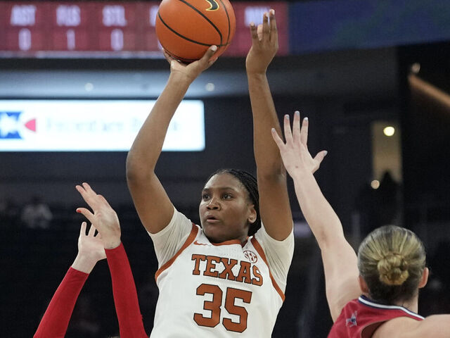 AUSTIN, TEXAS - NOVEMBER 7: Madison Booker #35 of the Texas Longhorns shoots over Ally Sweeney #14 and Maggie Doogan #44 of the Richmond Spiders during the first half at Moody Center on November 7, 2025 in Austin, Texas.