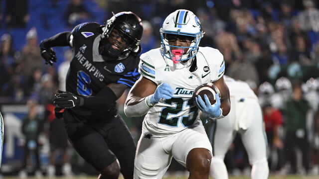 MEMPHIS, TENNESSEE - NOVEMBER 07: Javin Gordon #23 of the Tulane Green Wave runs with the ball in the first half of a game against the Memphis Tigers at Liberty Bowl Memorial Stadium on November 07, 2025 in Memphis, Tennessee.