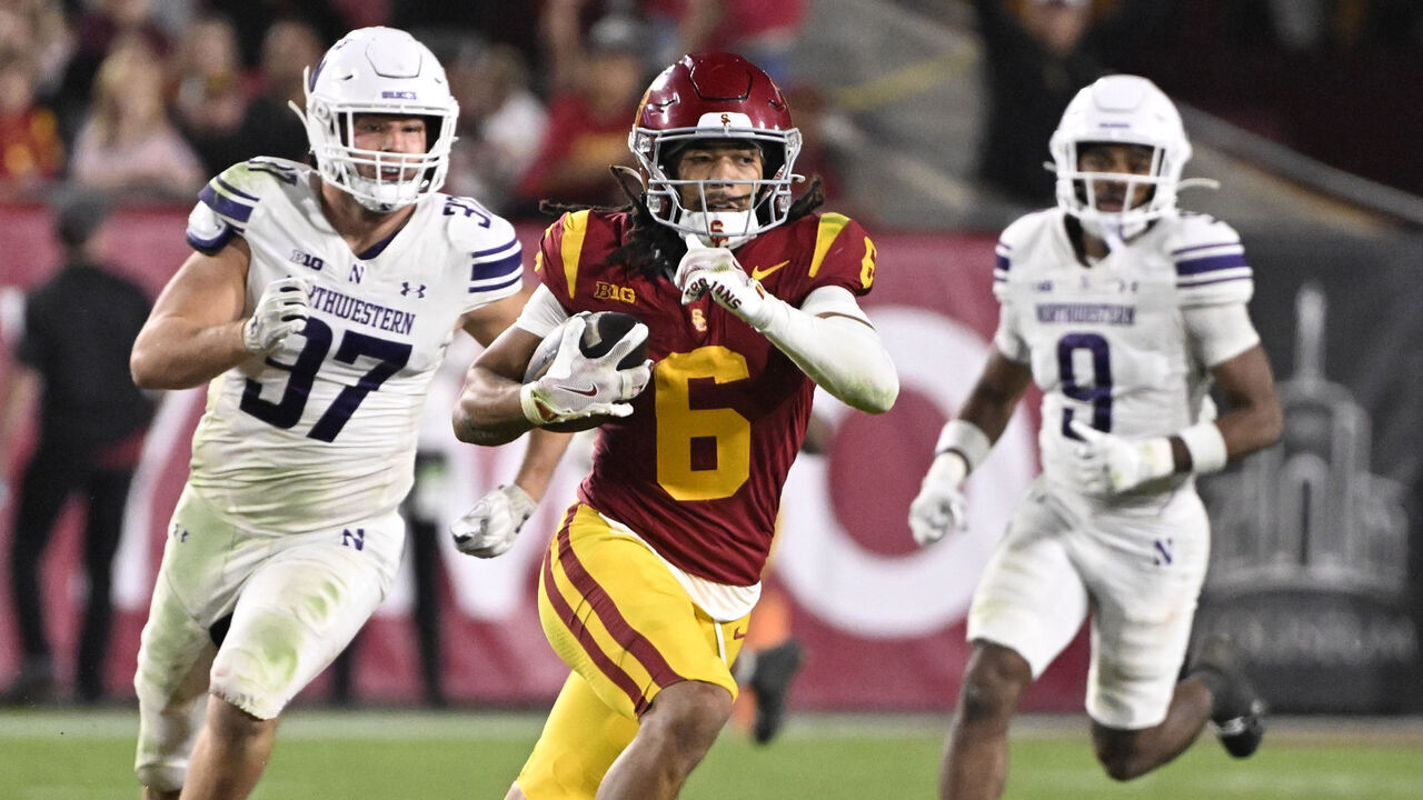 Los Angeles, CA - November 07: Wide receiver Makai Lemon #6 of the USC Trojans catches a pass for a 53 yard first down past defensive lineman Braxton Strong #97 of the Northwestern Wildcats in the second half of a NCAA football game at the Los Angeles Memorial Coliseum in Los Angeles on Friday, November 7, 2025.