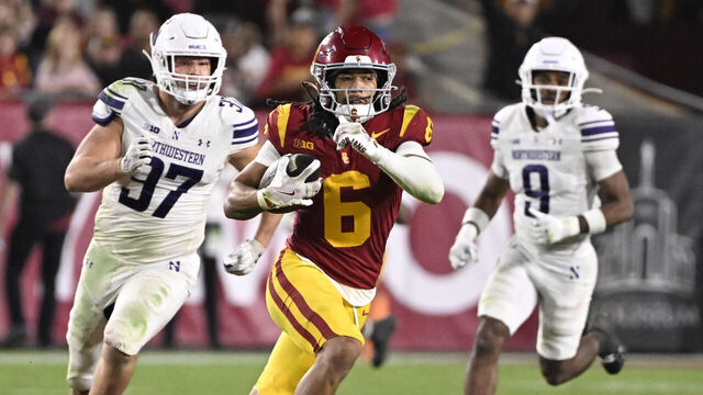 Los Angeles, CA - November 07: Wide receiver Makai Lemon #6 of the USC Trojans catches a pass for a 53 yard first down past defensive lineman Braxton Strong #97 of the Northwestern Wildcats in the second half of a NCAA football game at the Los Angeles Memorial Coliseum in Los Angeles on Friday, November 7, 2025.