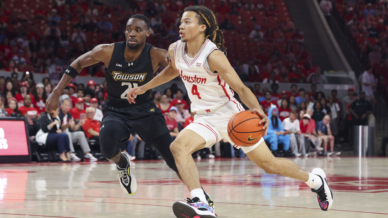 HOUSTON, TX - NOVEMBER 08: Houston Cougars guard Kingston Flemings (4) drives the ball past Towson Tigers guard Jack Doumbia Jr. (21) in the first half during the college men's basketball game between the Towson Tigers and Houston Cougars on November 8, 2025 at Fertitta Center in Houston, Texas.