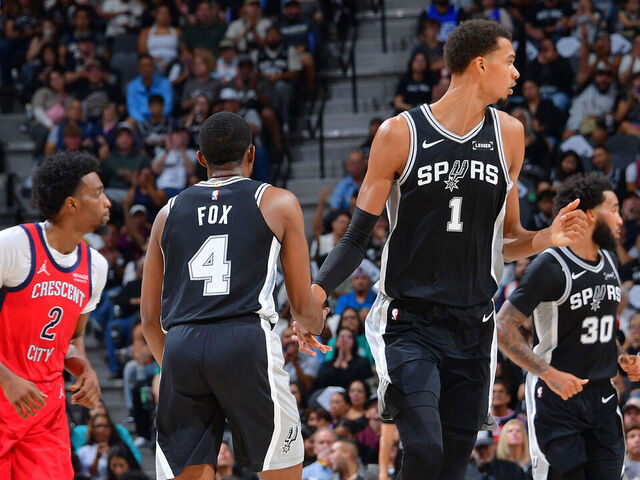SAN ANTONIO, TX - NOVEMBER 8: De'Aaron Fox #4 and Victor Wembanyama #1 of the San Antonio Spurs high five during the game against the New Orleans Pelicans on November 8, 2025 at the Frost Bank Center in San Antonio, Texas. Mandatory Copyright Notice: Copyright 2025 NBAE (Photos by Michael Gonzales/NBAE via Getty Images)