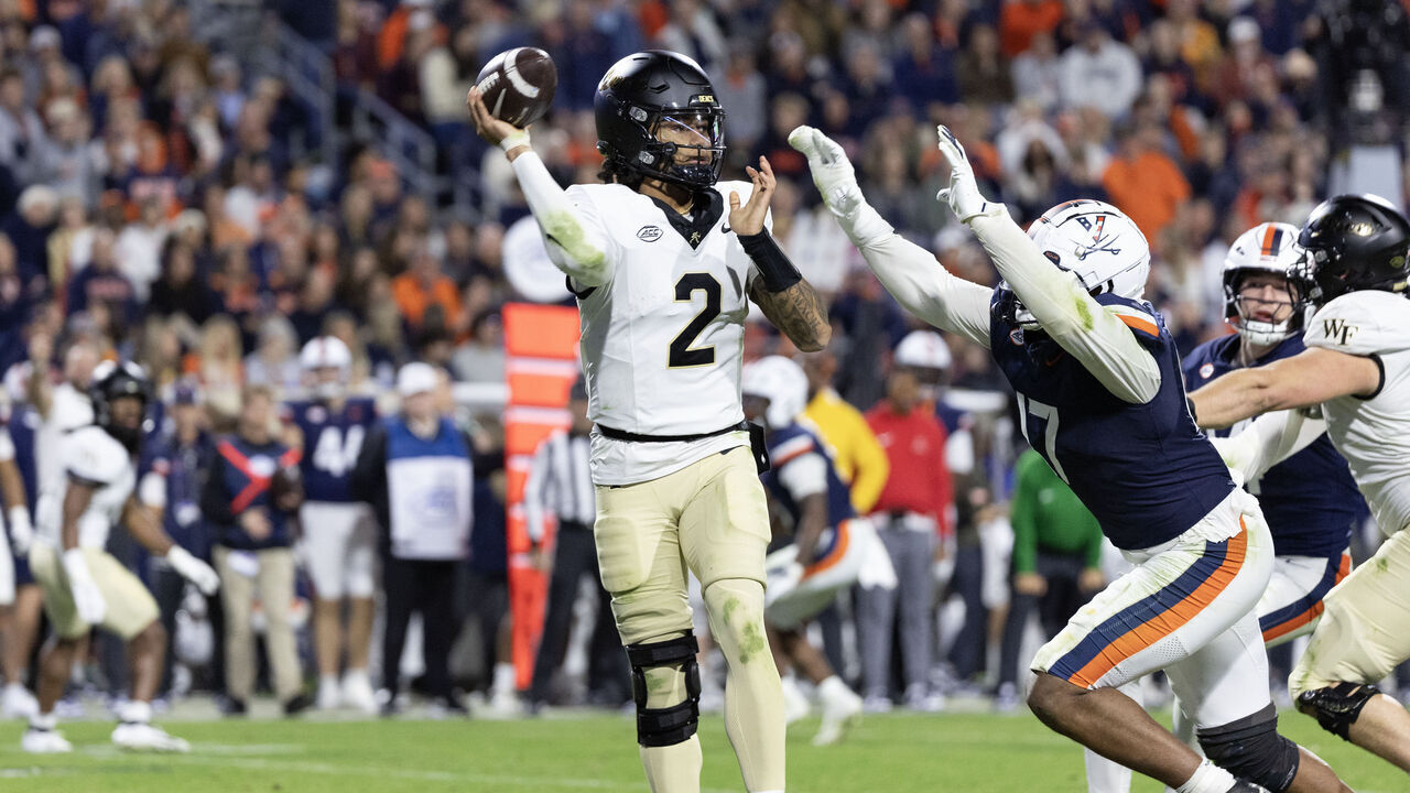 CHARLOTTESVILLE, VIRGINIA - NOVEMBER 08: Robby Ashford #2 of the Wake Forest Demon Deacons throws a pass under pressure from Mitchell Melton #17 of the Virginia Cavaliers in the second half during a game at Scott Stadium on November 8, 2025 in Charlottesville, Virginia.