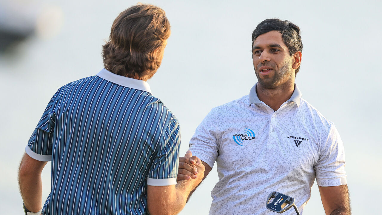 ABU DHABI, UNITED ARAB EMIRATES - NOVEMBER 09: Aaron Rai of England embraces Tommy Fleetwood after he had won on the 18th green in the first hole of the sudden-death play-off during the final round of the Abu Dhabi HSBC Championship 2025 at Yas Links Golf Course on November 09, 2025 in Abu Dhabi, United Arab Emirates.