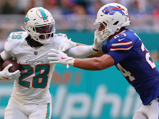 MIAMI GARDENS, FLORIDA - NOVEMBER 09: De'Von Achane #28 of the Miami Dolphins carries the ball defended by Cole Bishop #24 of the Buffalo Bills during the first quarter in the game at Hard Rock Stadium on November 09, 2025 in Miami Gardens, Florida.