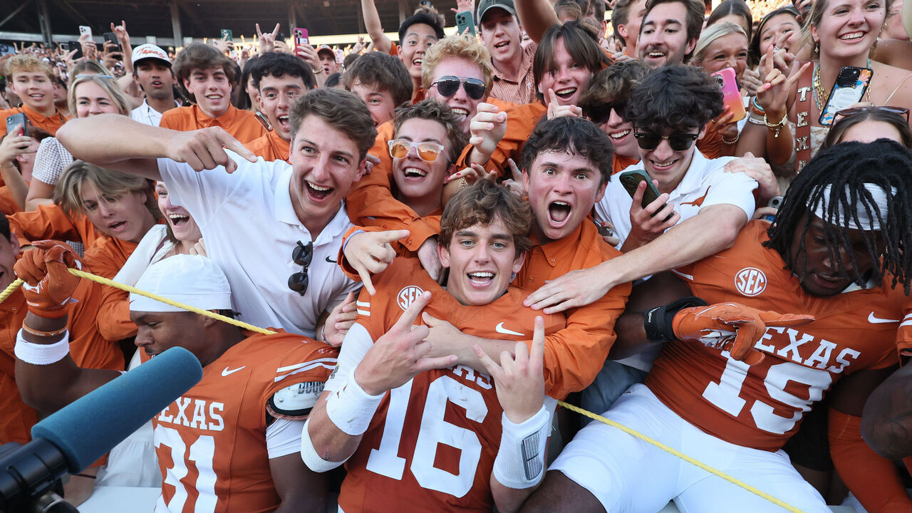 DALLAS, TEXAS - OCTOBER 11: Arch Manning #16 of the Texas Longhorns celebrates with fans after defeating the Oklahoma Sooners at Cotton Bowl Stadium on October 11, 2025 in Dallas, Texas.